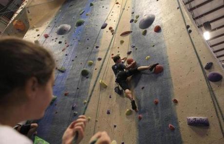Katie Price of Boston watched friend Mimi Lin also from Boston try a route at Central Rock Gym in Watertown. 
